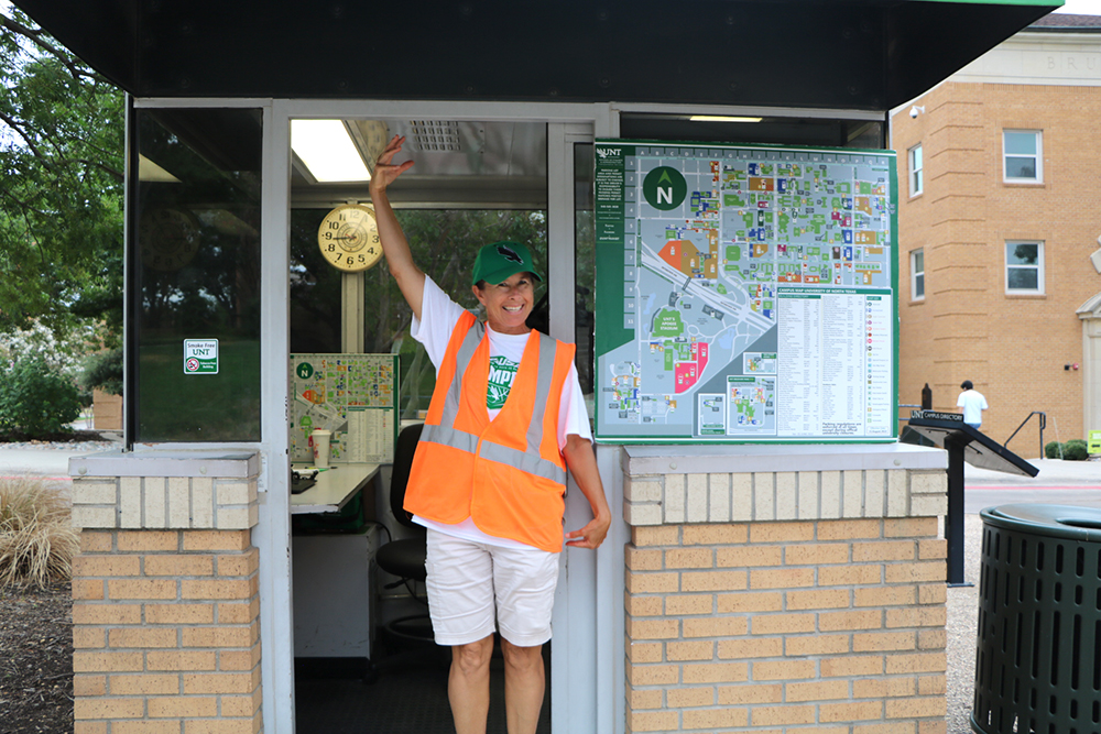 parking attendant smiling and waving