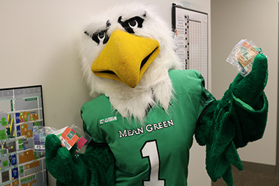 Scrappy mascot holding old parking permits