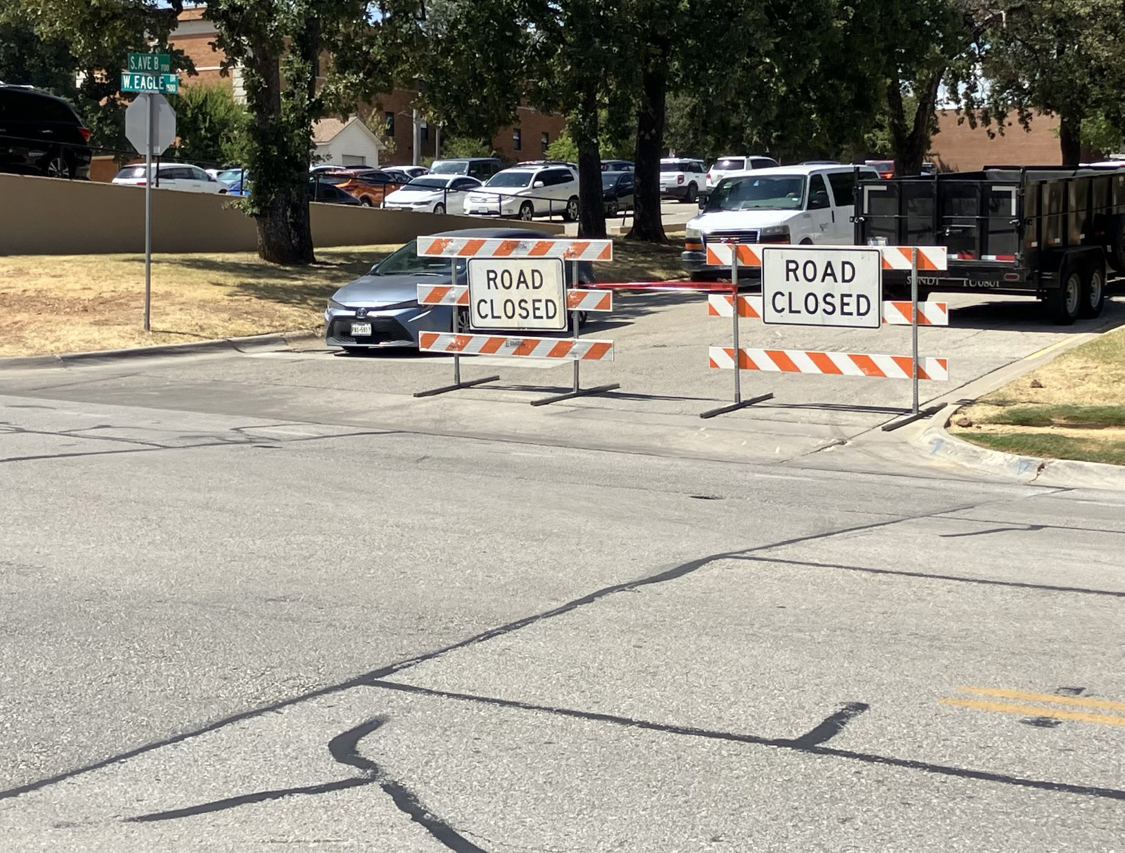 a pair of road closed signs along Avenue B on campus