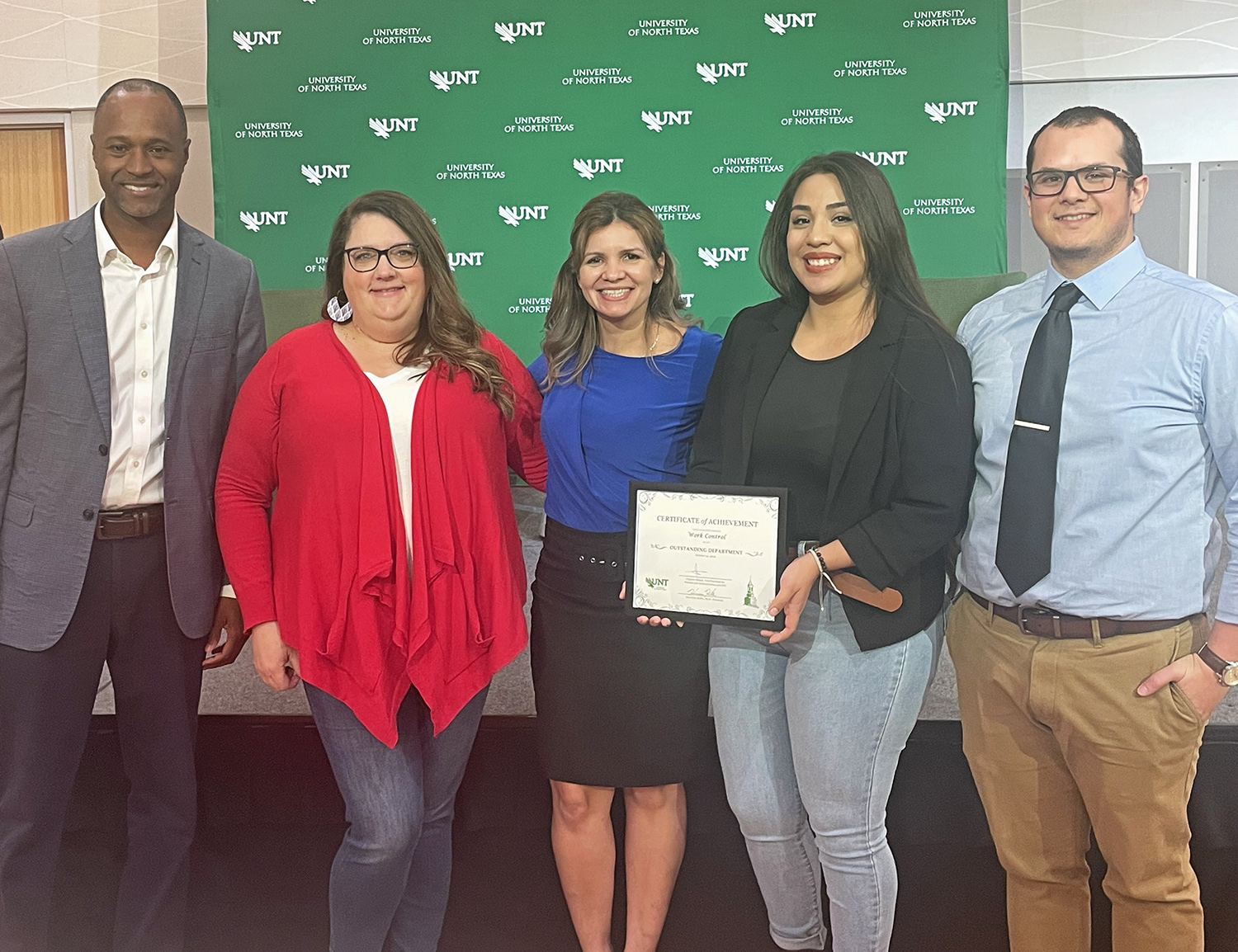 Vice President Clayton Gibson stands with staff from the Work Control team and their award.