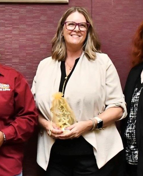 Sally Carne holding an award