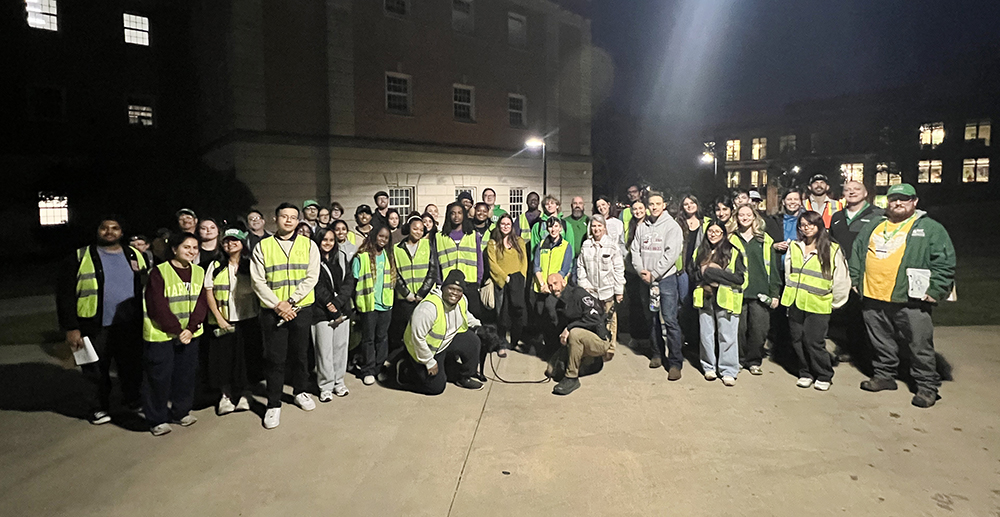 A group of people in safety vests posing for a picture before the Safety Walk starts.