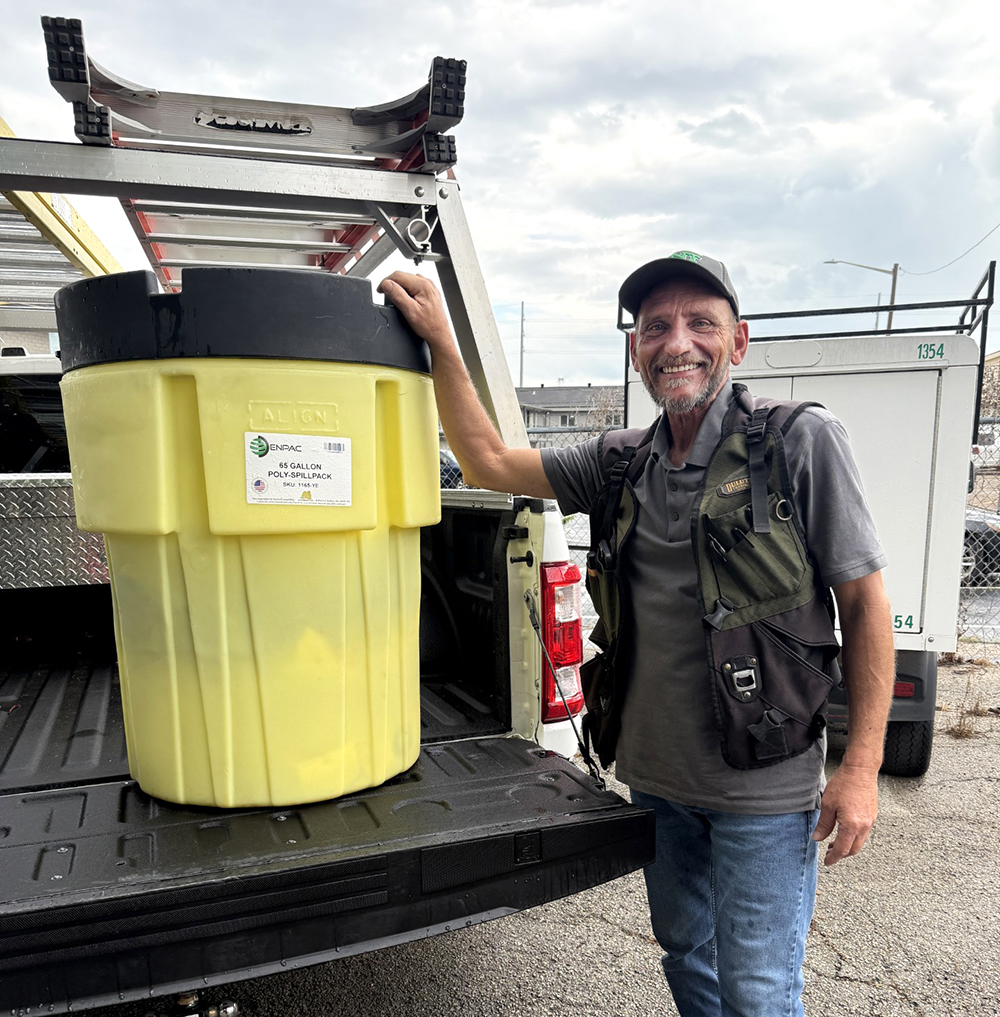 Electrician Lou Passantino standing next to his specially designed spill kit.