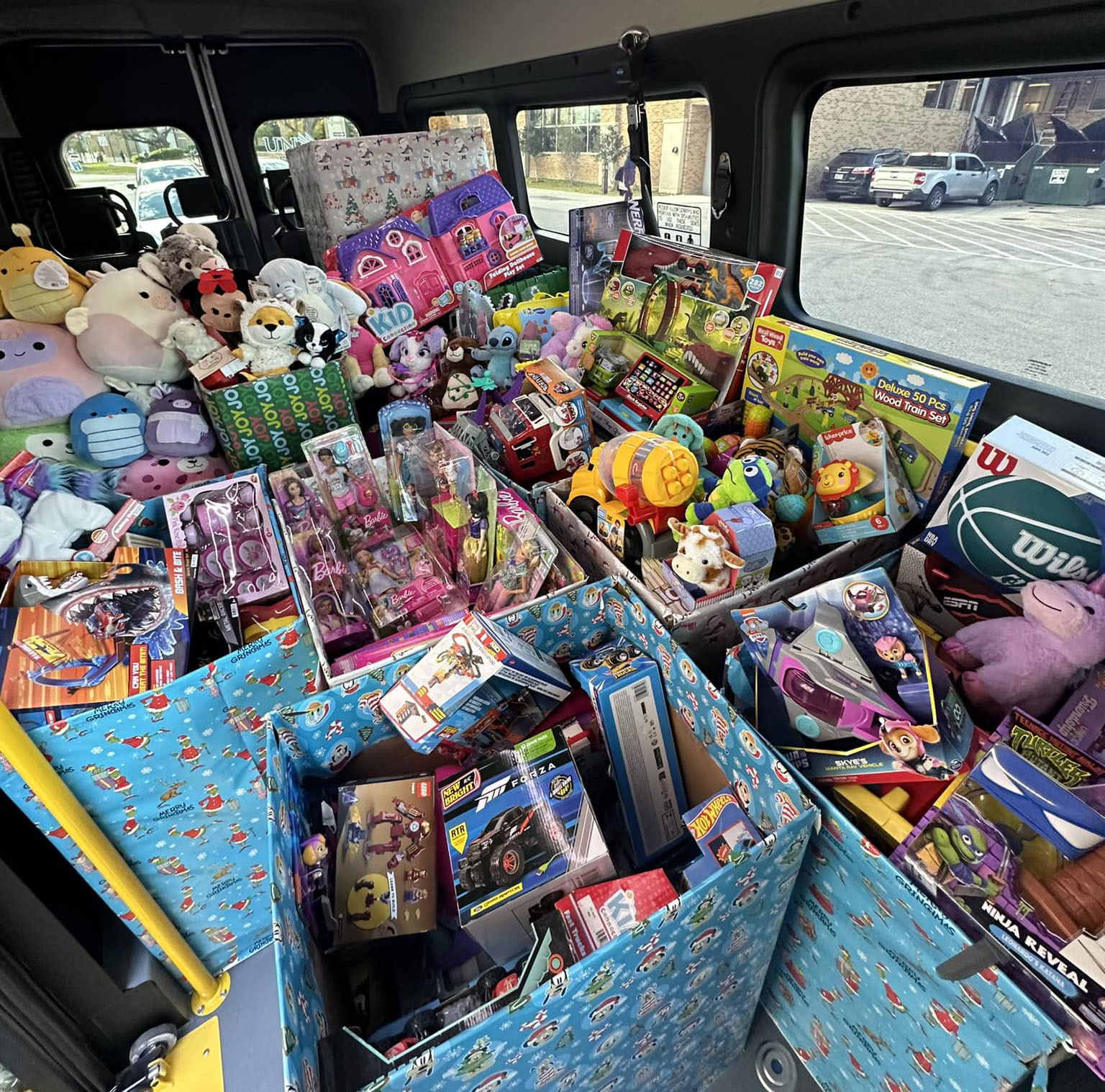 toys in boxes filling the inside of a bus