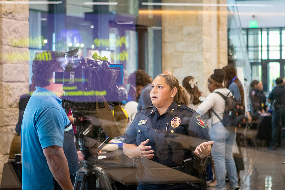 Chief Ramona Washington being interviewed by a TV reporter at the event